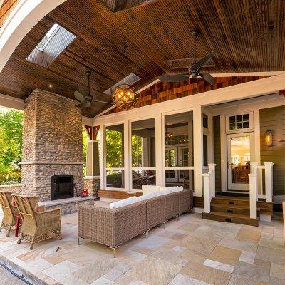 covered outdoor living space with sky lights and stone fireplace